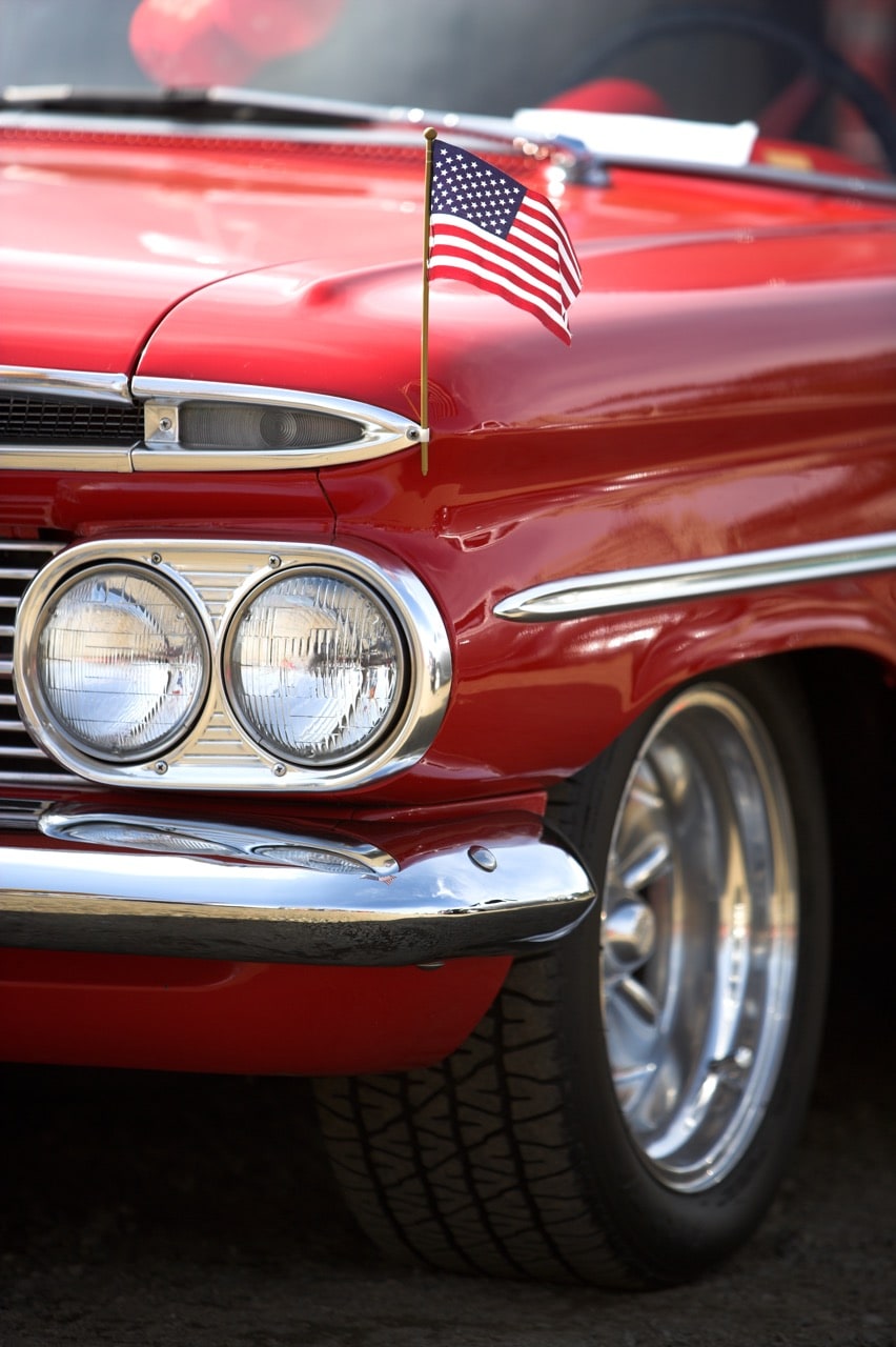 American flag on classic red car