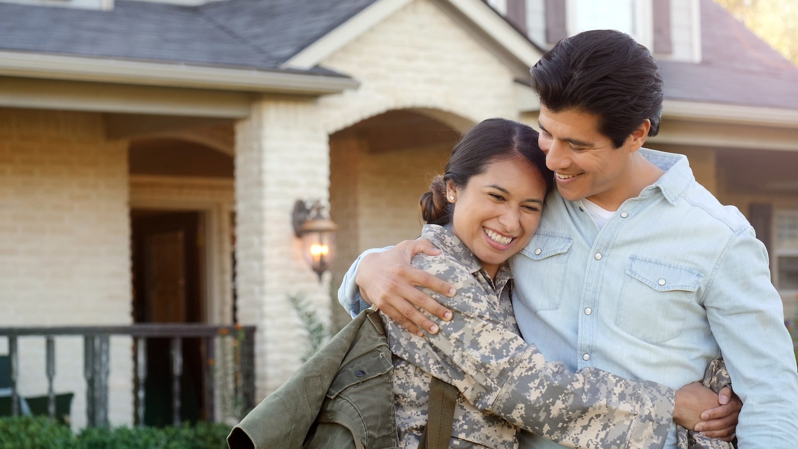 Couple celebrating in front of a new home