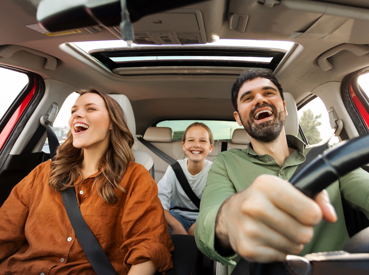 Family enjoying a drive in their new car