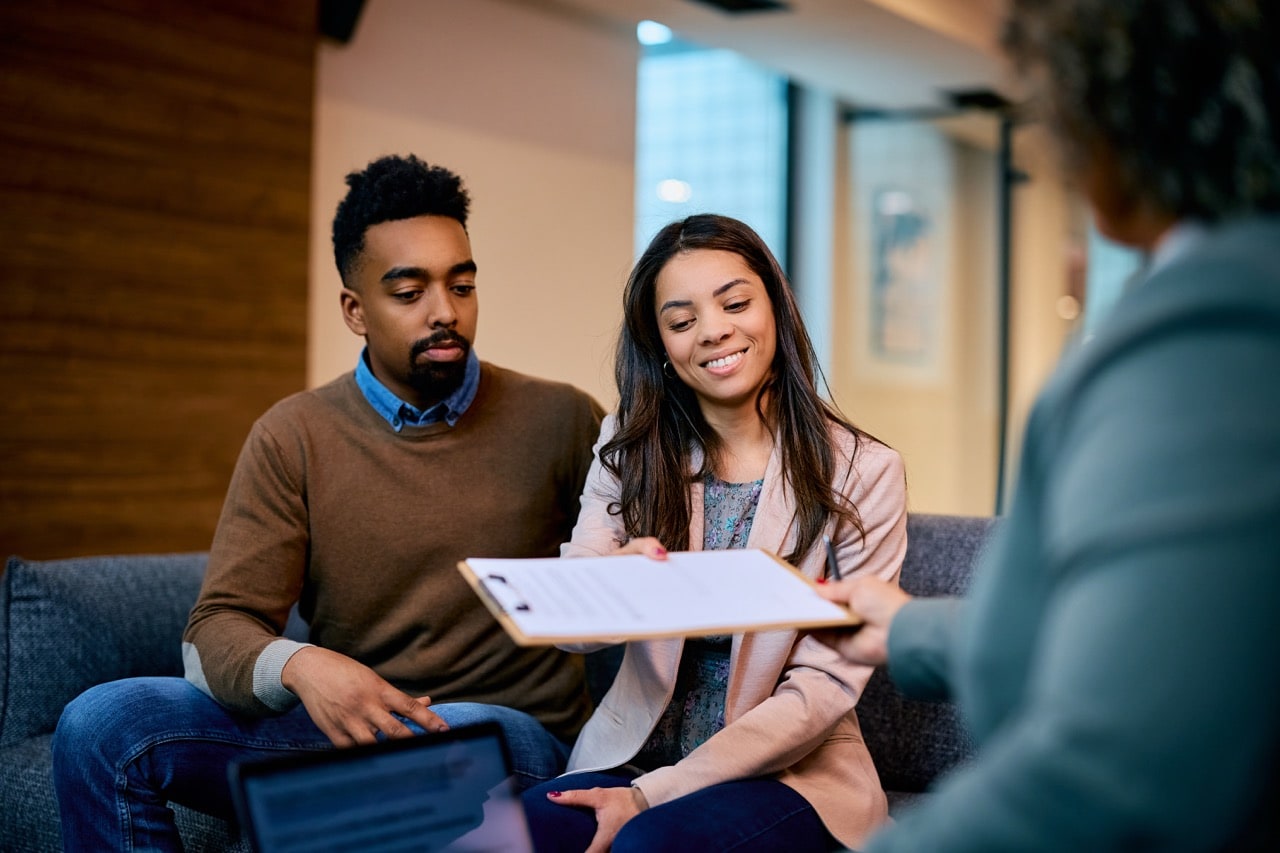 Borrowers reviewing mortgage requirements with a lending specialist