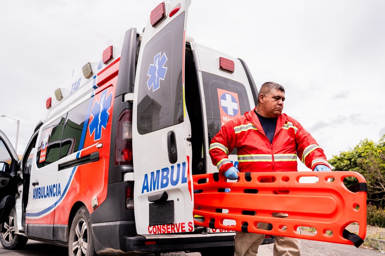 Paramedic taking a stretcher from an ambulance