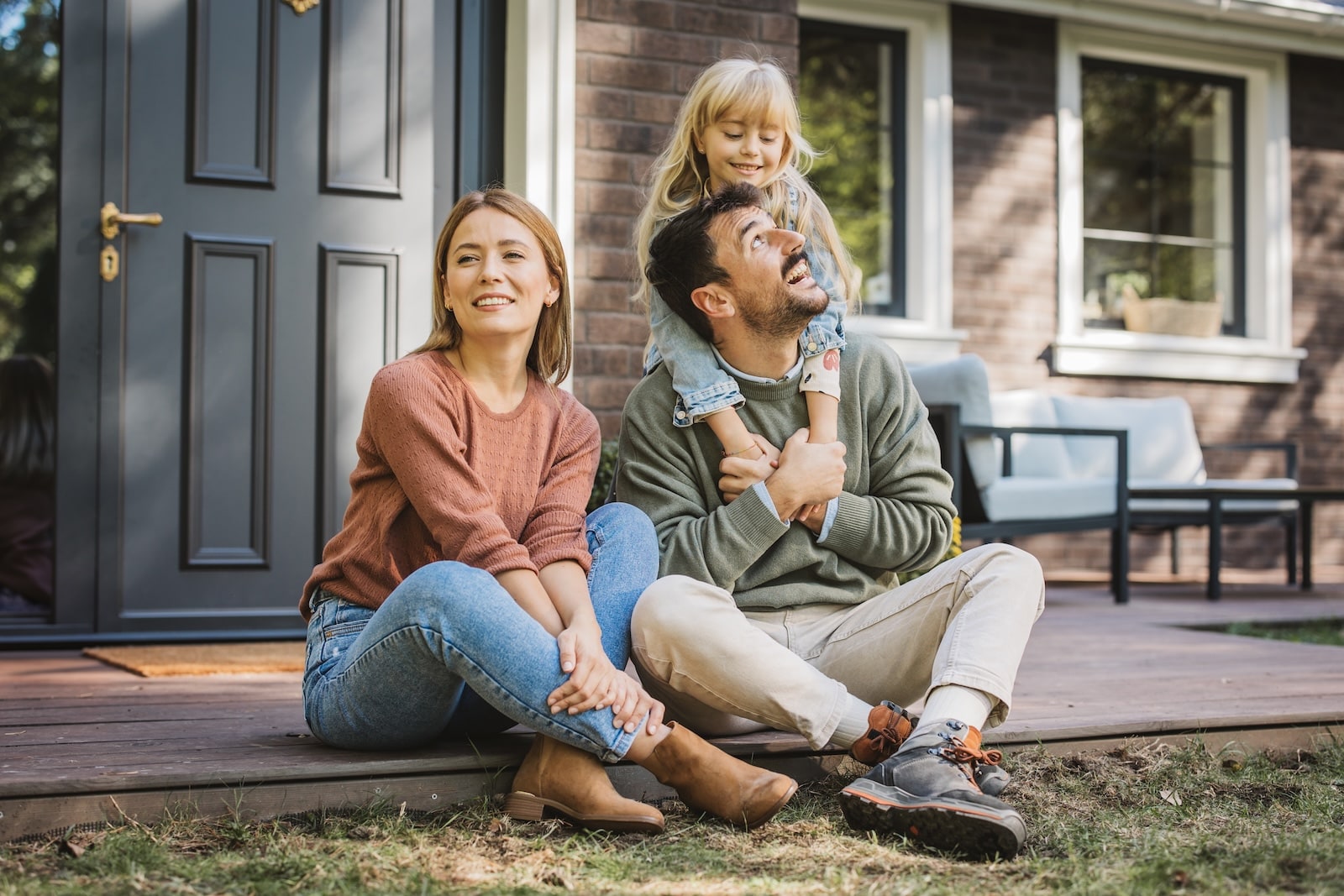 Family enjoying time together outside their home