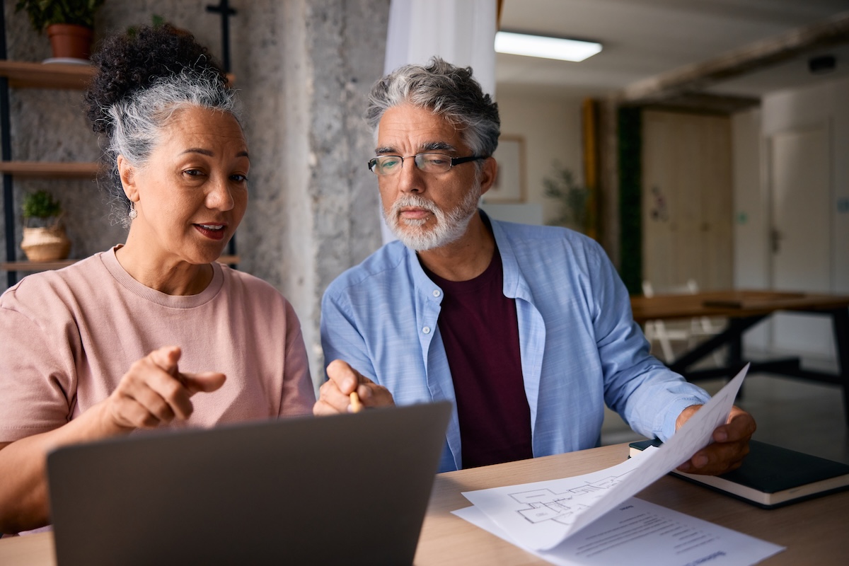 Couple reviewing home project plans and financing paperwork