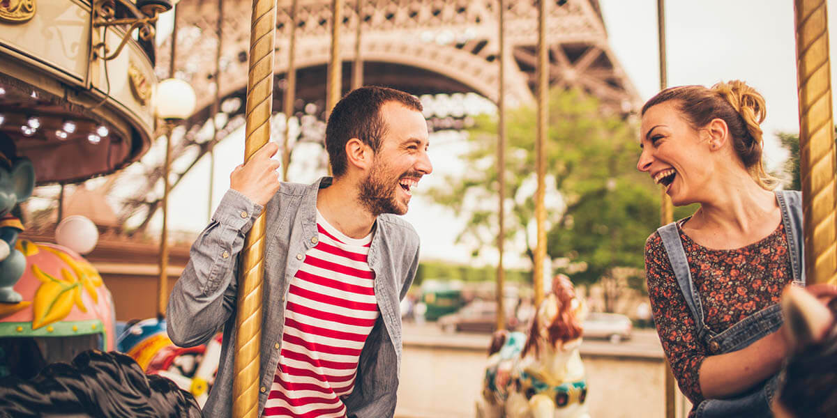 Smiling couple at the Eiffel Tower in Paris