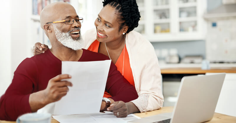 Happy middle aged couple making a plan for retirement.