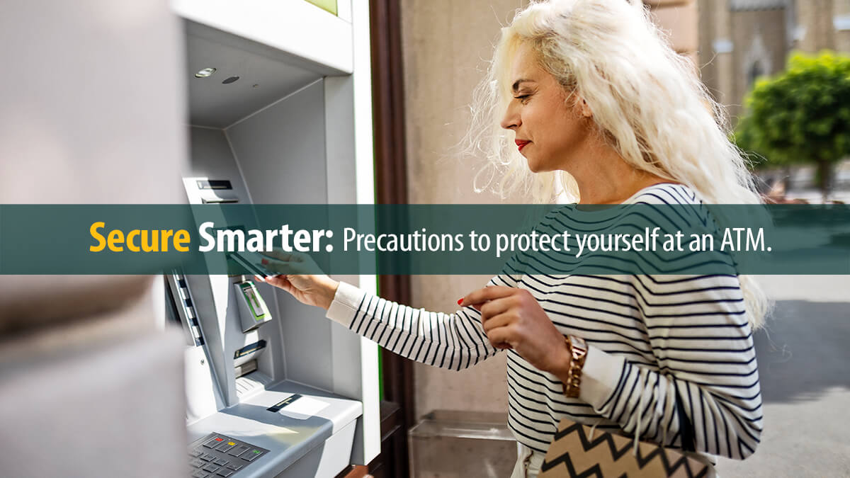 Mature woman using an ATM holding shopping bags.