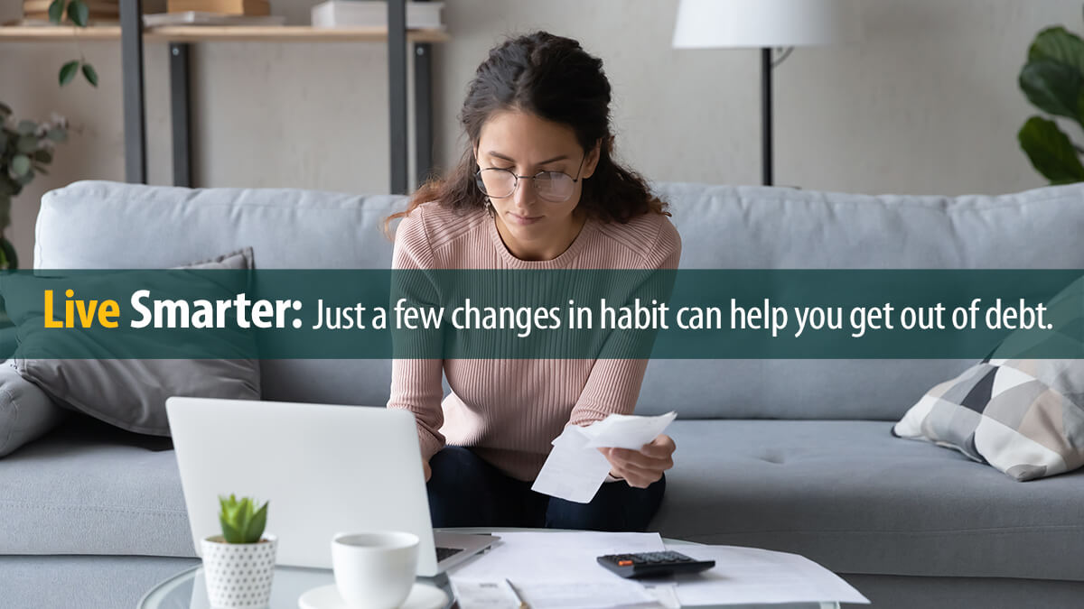 Young woman manages her finances using laptop