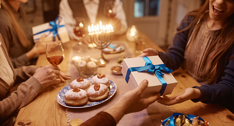 Jewish girl receiving present from her father on Hanukkah.