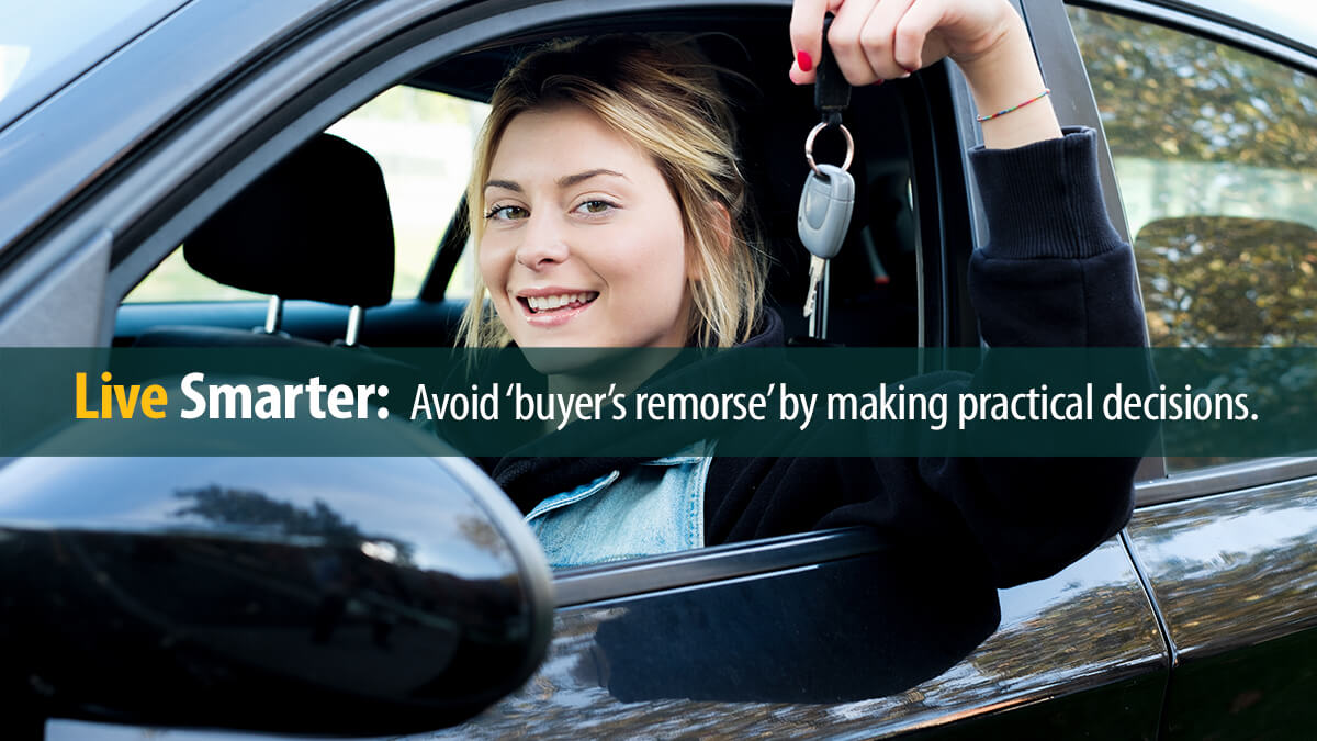 Young woman holding car key seated in her new car