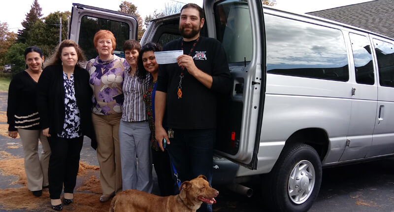 First Source FCU staff members present a check to Stevens-Swan Humane Society employees.