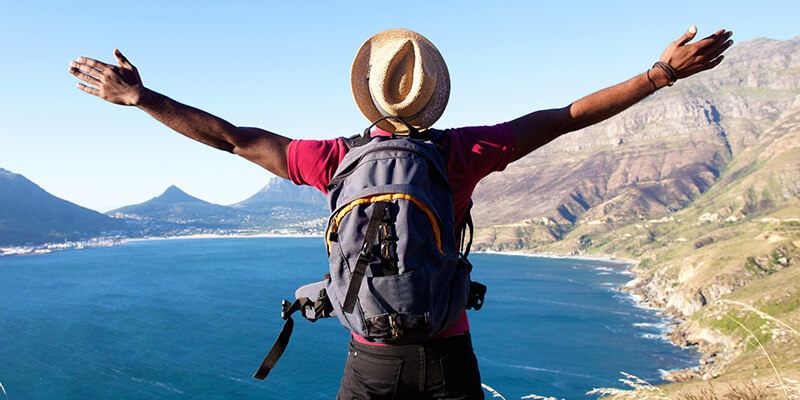 Man enjoying a beautiful view on vacation he financed