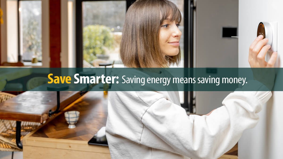 Woman controlling home temperature with electronic thermostat