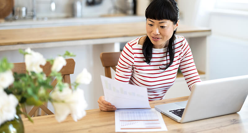 Adult Asian woman reviewing finances