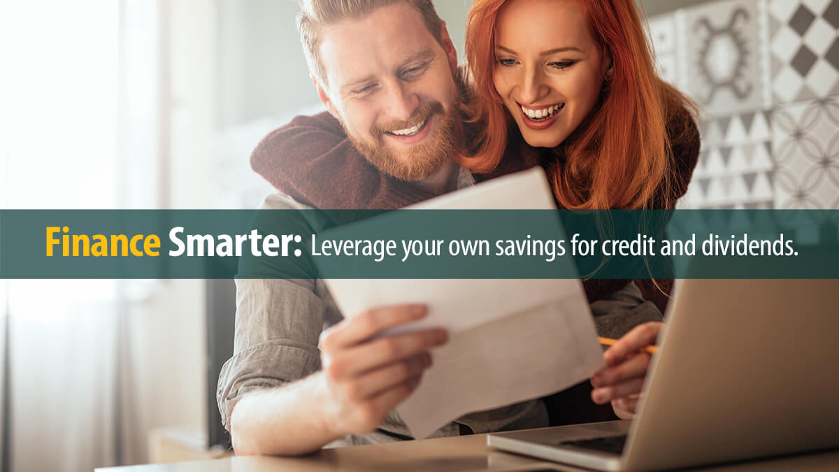 Young couple embracing and calculating the bills at home.