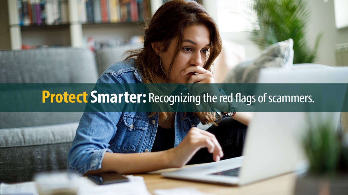 Worried young woman working on a laptop