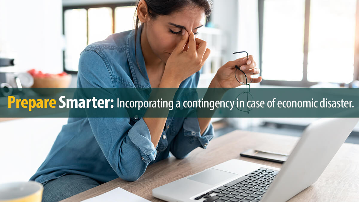 Stressed woman on laptop looking worried, tired and overwhelmed.